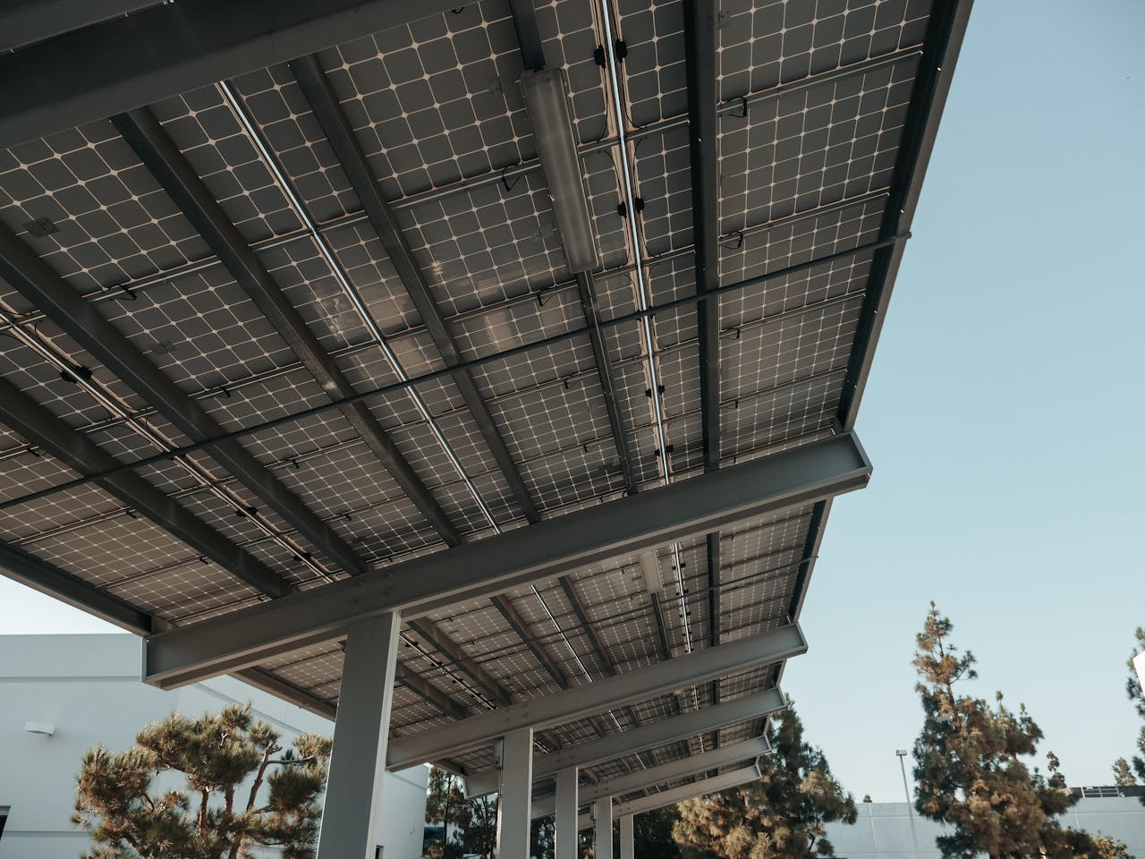 Low-angle view of solar panels under a clear sky, highlighting clean energy.